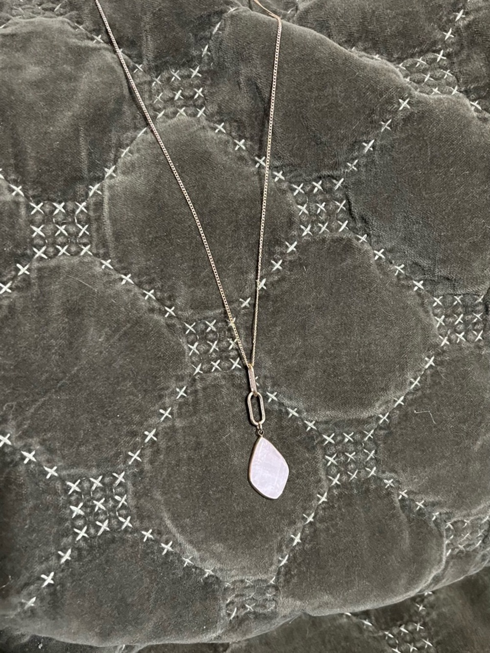 Pink and gold coloured pendant.